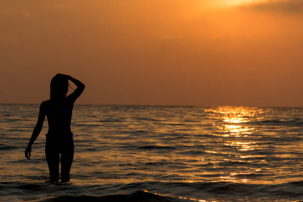 istock silhouette woman on the beach 667315450