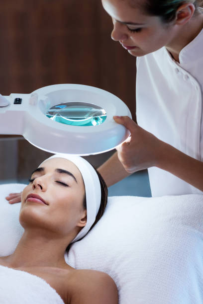 istock Masseuse looking at woman face 667320792