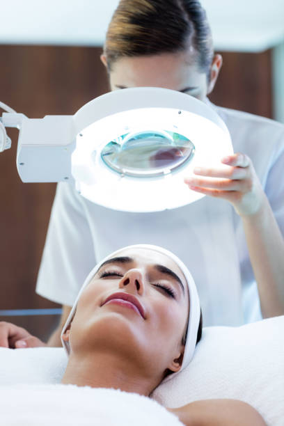 istock Masseuse looking at woman face 667323270