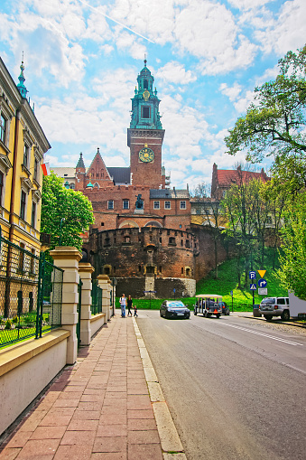 Krakow, Poland - May 1, 2014: Bell tower of Wawel Cathedral on the hill and people at Krakow city center, Poland.