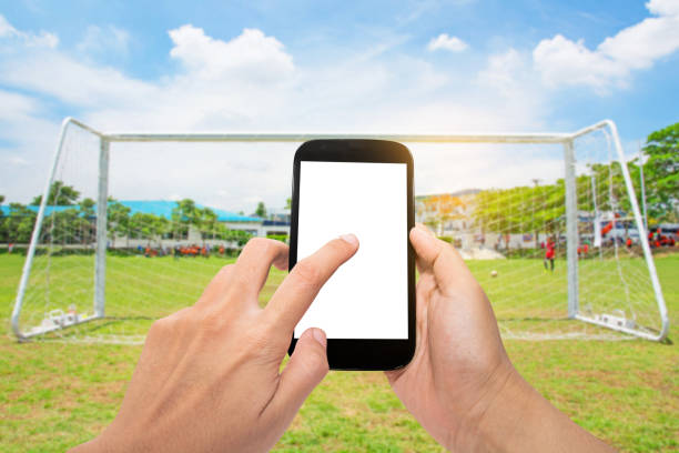 istock Man use mobile with football 667324080