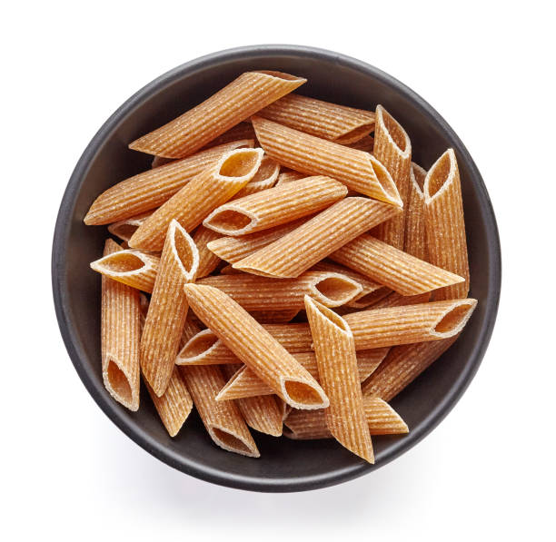 istock whole grain pasta in bowl isolated on white, from above 667324402