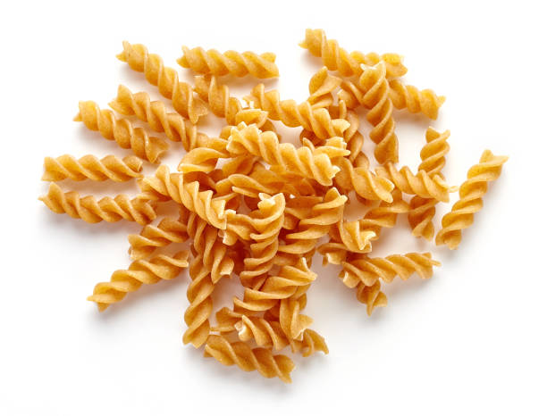 istock whole grain pasta in bowl isolated on white, from above 667324412
