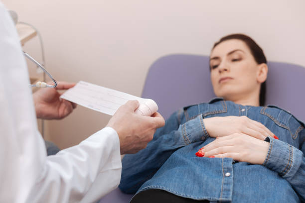 istock Commuted excellent specialist examining ladies electrocardiographic tracings 667324980