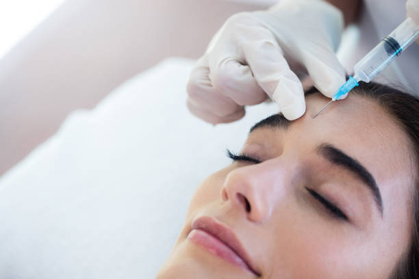 istock Woman receiving botox injection 667327930