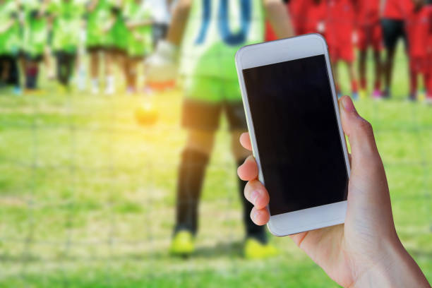 istock smartphone with young boy as a soccer 667328428