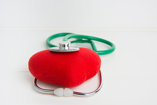 Red heart and a stethoscope. Healthcare And Medicine concept studio shot. Isolated on white background.