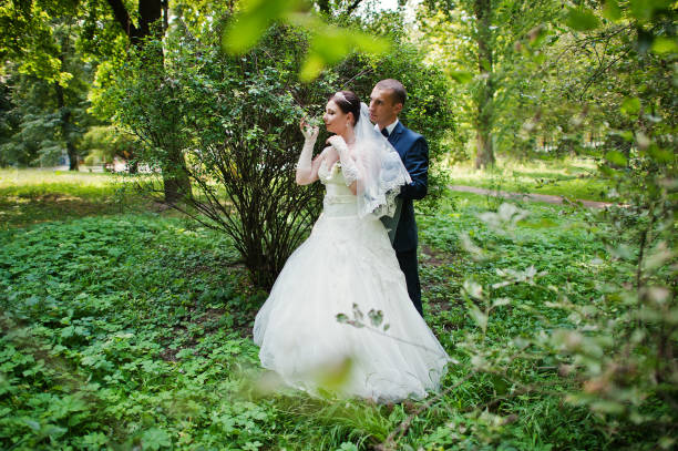 istock just married in love walking at the park 667329306