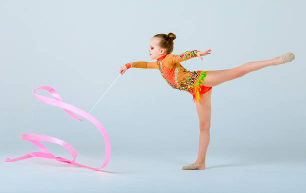 istock Little Artistic Gymnast Performs With Ribbon 667329392
