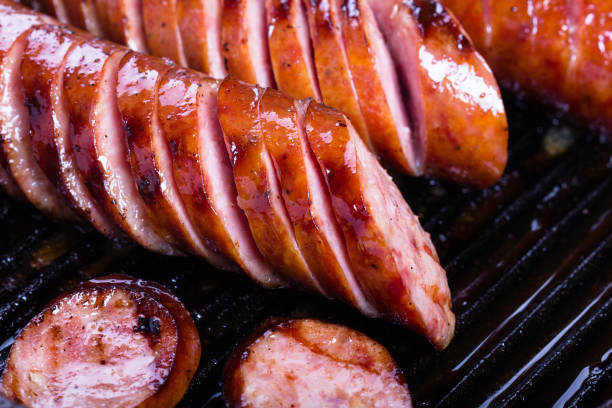 istock Fried pork sausages on a cast iron skillet. 667333004