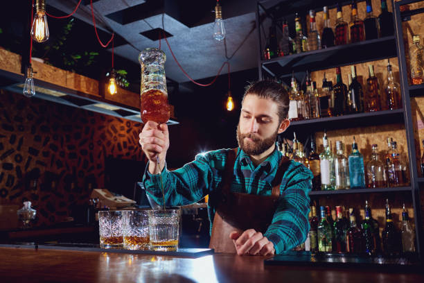 istock The barman pours alcohol into a glass 667340450