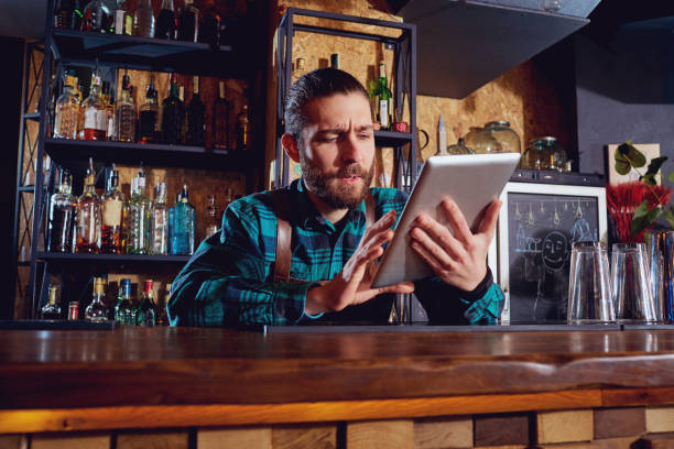 istock Waiters, bartenders barista work with the tablet in cafe bar res 667340632