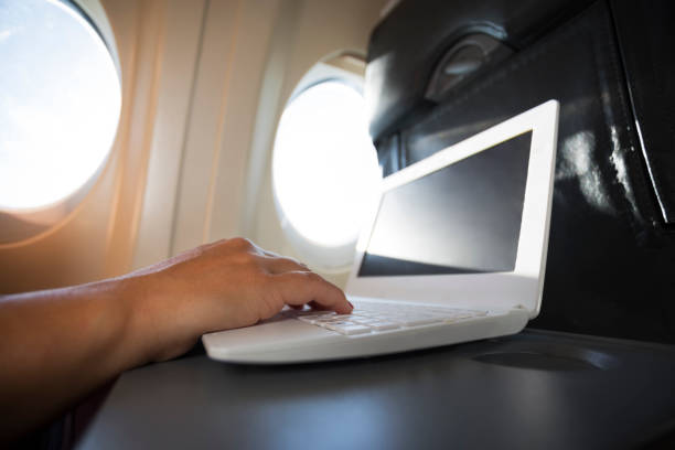 istock Woman Using Laptop in airplane during flight 667342232