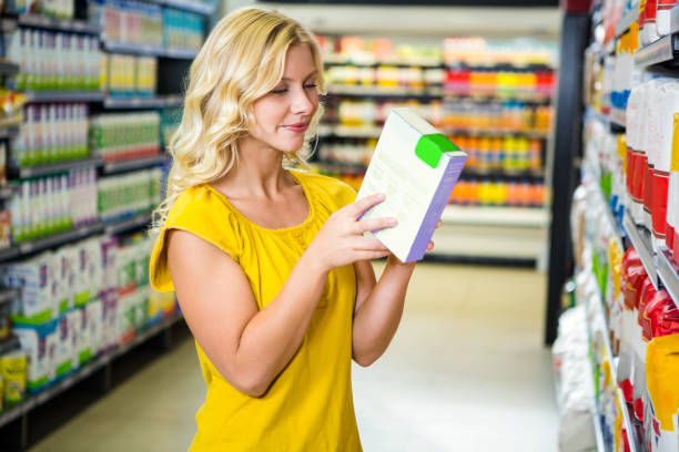 istock Smiling pretty blonde woman reading a box 667345088