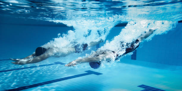 istock swimmer  Jump from platform jumping A swimming pool.Underwater photo 667345874