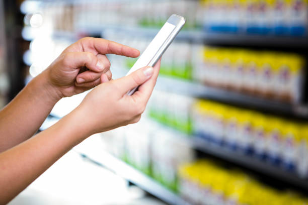 istock Cropped view of woman using her smartphone 667346476