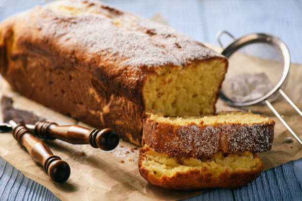 istock Sliced vanilla pound cake on wooden background. Selective focus. 667353136