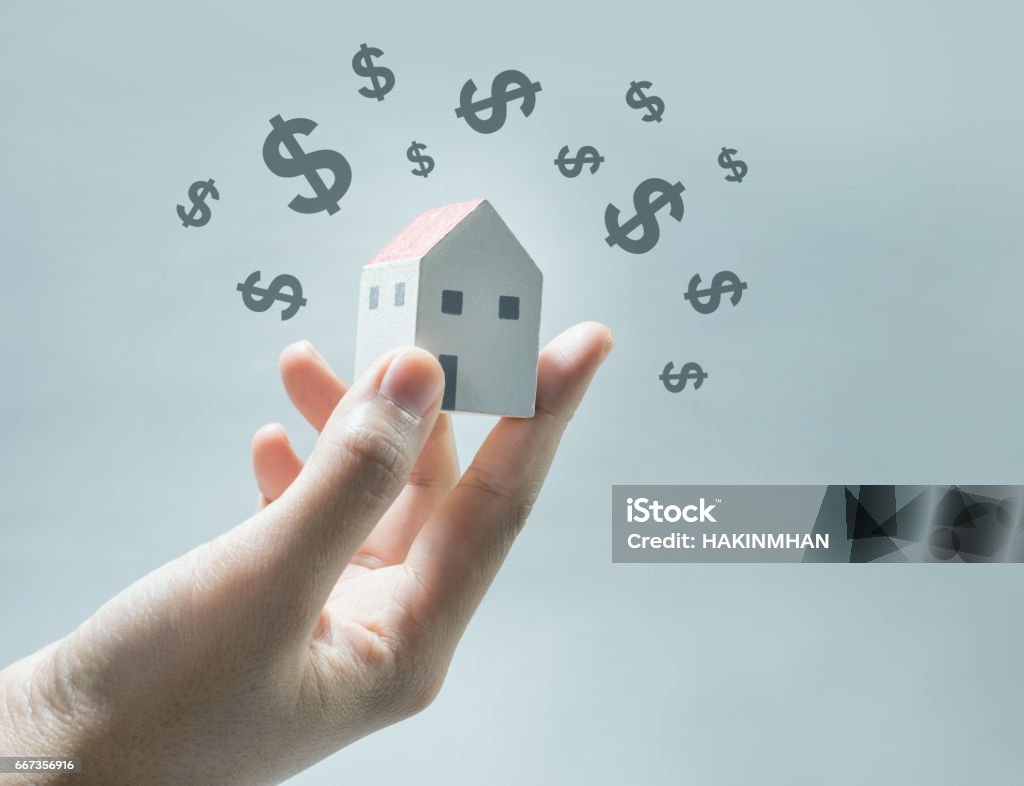 House model on human hands with dollar icon. House model on human hands with dollar icon.Savings money and real estate concept House Stock Photo