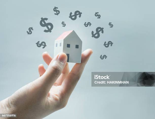 House Model On Human Hands With Dollar Icon Stock Photo - Download Image Now - House, Real Estate, Investment