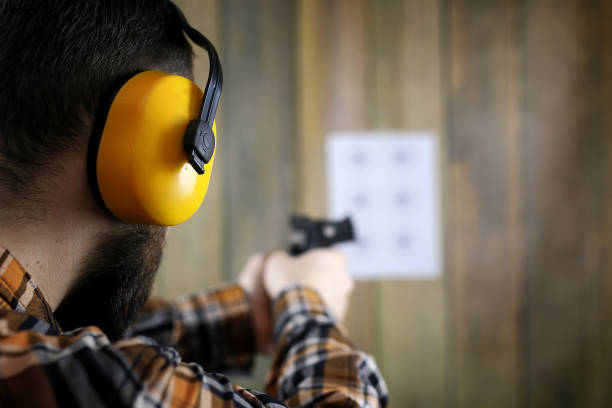 istock man with put on protective goggles and ear training in pistol sh 667357260