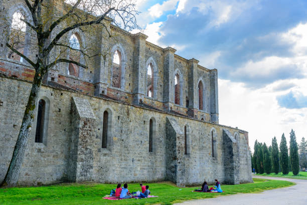 Chiusdino, Italy - April 9, 2017: A family eat and have fun in the meadow next the Abbey of San Galgano in Chiusdino.