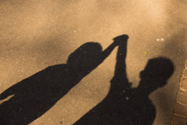 istock Shadow of childs on sidewalk 667360636