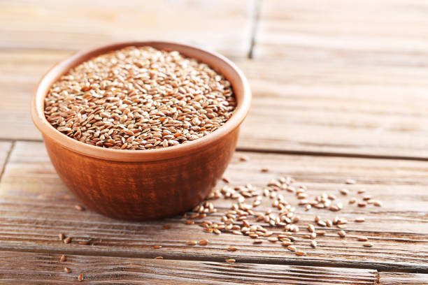 istock Brown flax seeds on a wooden table 667364050