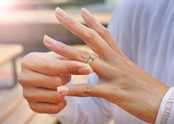 istock Woman is taking off the wedding ring 667364290