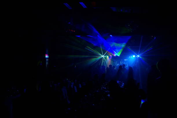 istock cheering crowd in front of bright stage lights 667365382