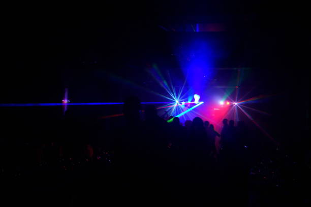 istock cheering crowd in front of bright stage lights 667365552