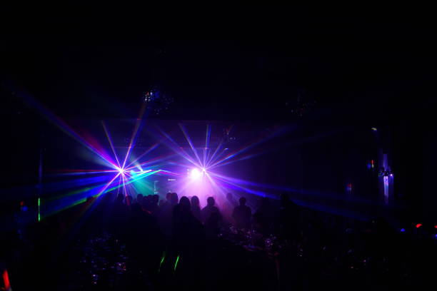 istock cheering crowd in front of bright stage lights 667365634