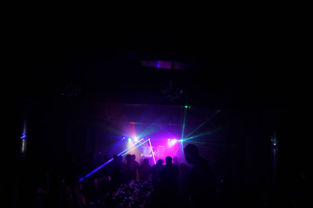 istock cheering crowd in front of bright stage lights 667365644