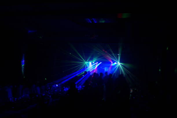 istock cheering crowd in front of bright stage lights 667365986