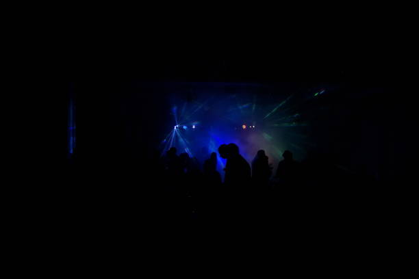 istock cheering crowd in front of bright stage lights 667366072