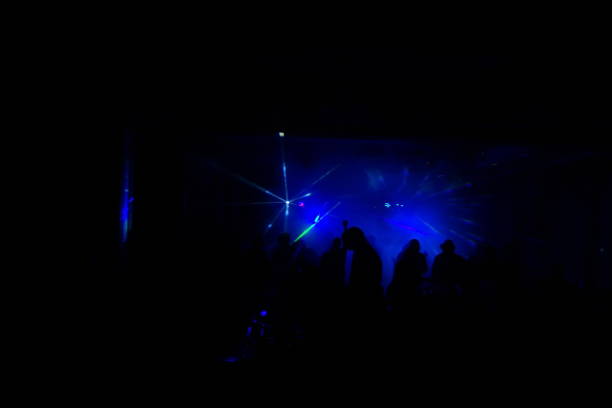 istock cheering crowd in front of bright stage lights 667366084