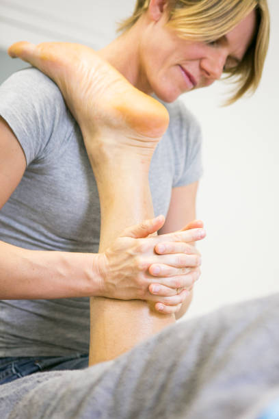 istock Sports massage on stiff calf muscle 667368010