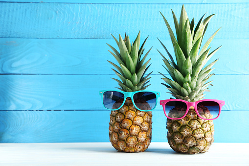 Ripe pineapples on a white wooden table