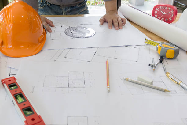 istock Interior designer discussing data and digital tablet and computer laptop with business document and graphics design diagram on wooden desk as concept 667372294