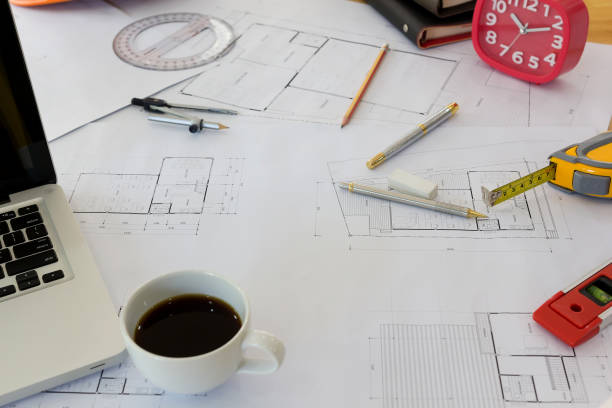 istock Interior designer discussing data and digital tablet and computer laptop with business document and graphics design diagram on wooden desk as concept 667372364