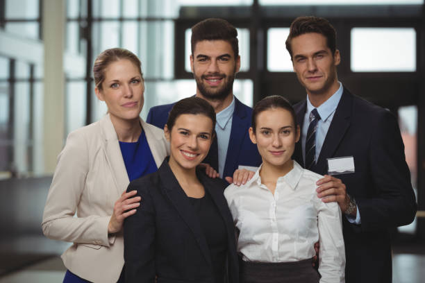 istock Successful businesspeople standing together in office 667372666
