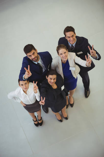 istock Successful businesspeople showing victory sign 667372892