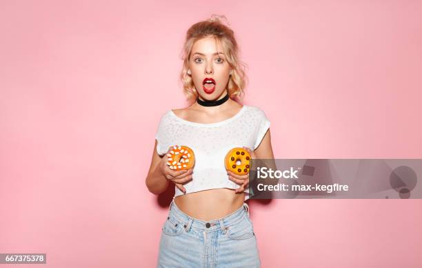 Woman Standing With Donuts Stock Photo - Download Image Now - Breast, Large, Women