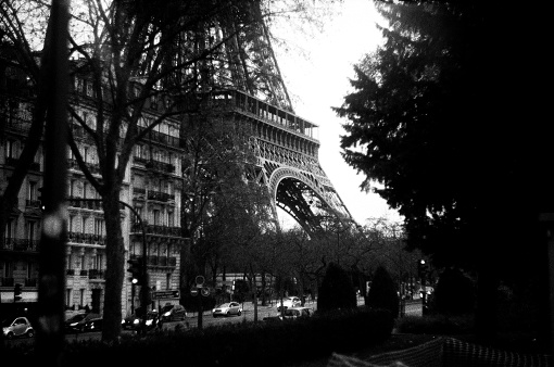 A close up of the Eiffel Tower in Paris, shot on black and white film.