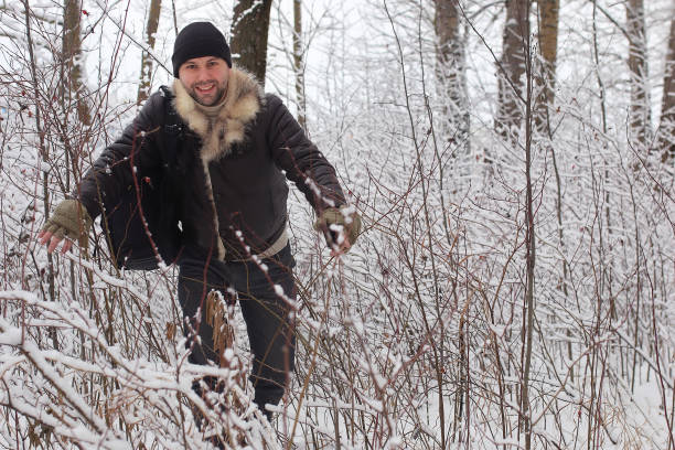 istock bearded man walking in a winter park 667379734