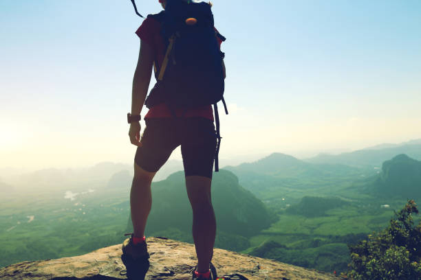 istock young woman backpacker enjoy the view on mountain peak 667380192