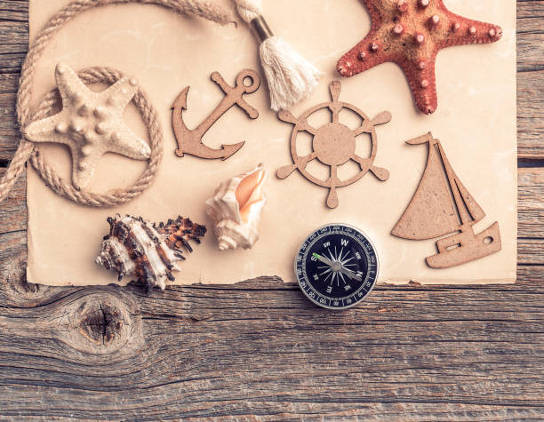 istock Compass, anchor, old paper with sea accessories. 667380284