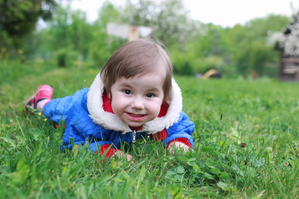 istock girl little outdoor tree lawn 667380638