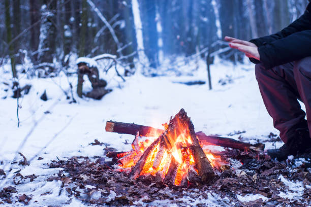 winter forest, the tourist warm tea in a pot, snow