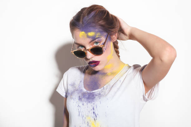istock Confident girl with Holi powder on face 667394312