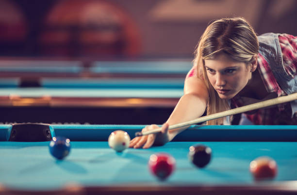 istock Young concentrated woman playing snooker in a bar. 667394510